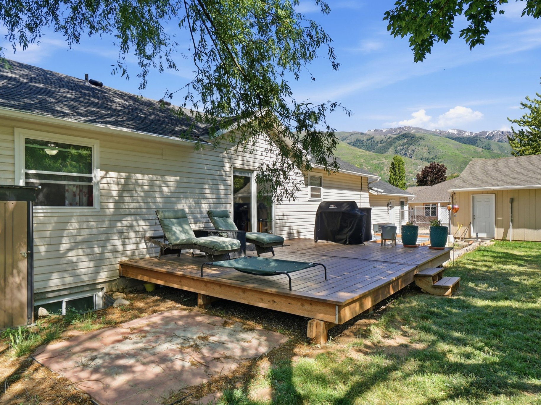 Expansive wooden deck with steps, offering outdoor living space
