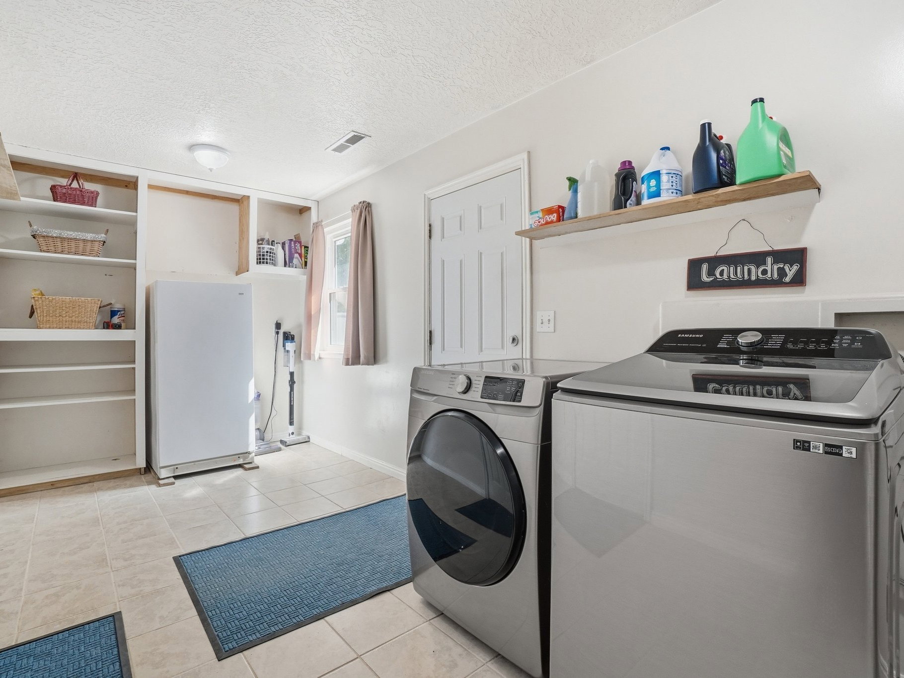 Dedicated laundry area featuring tiled flooring