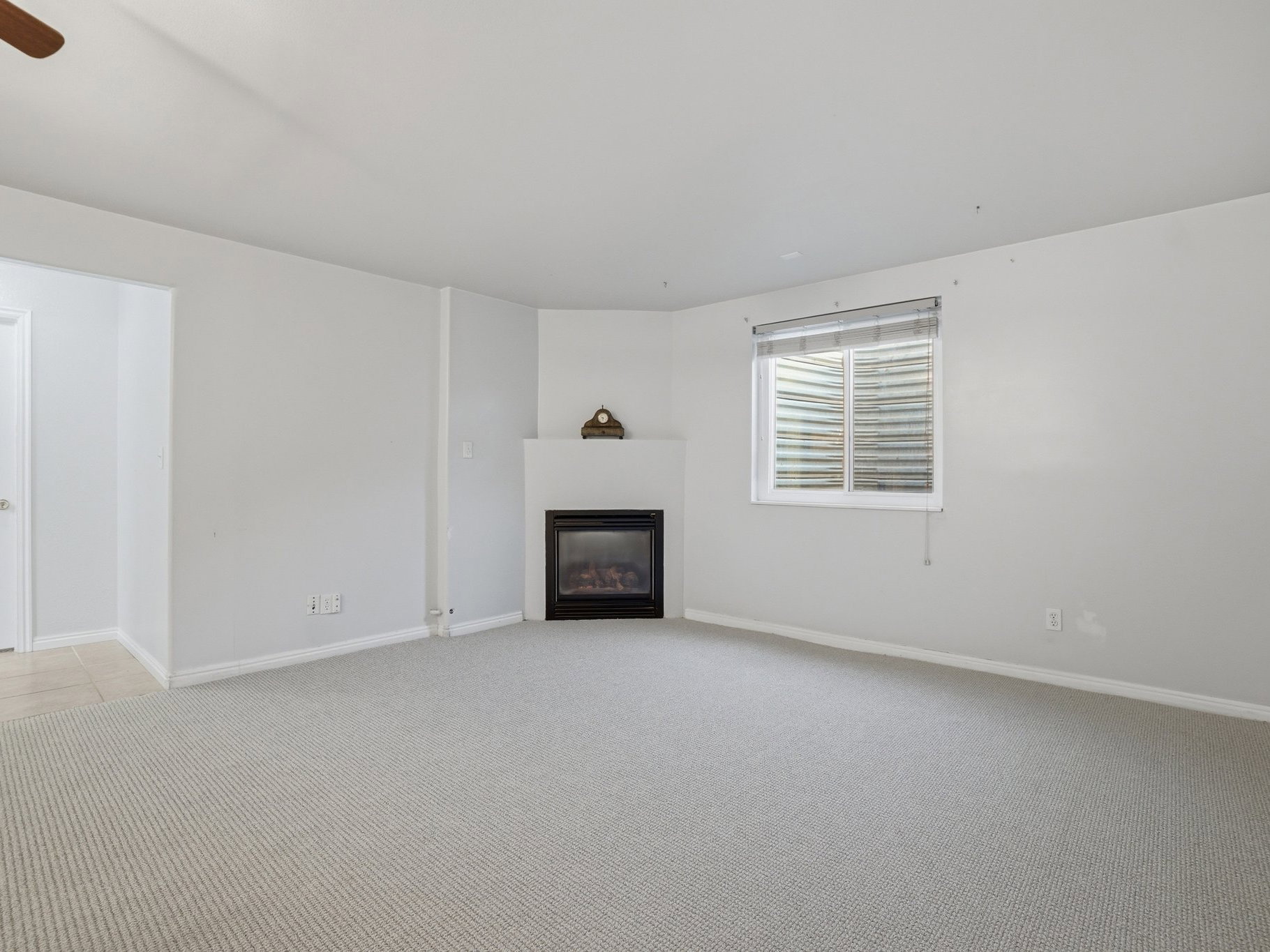 Spacious room featuring light-toned carpeting and neutral wall tones