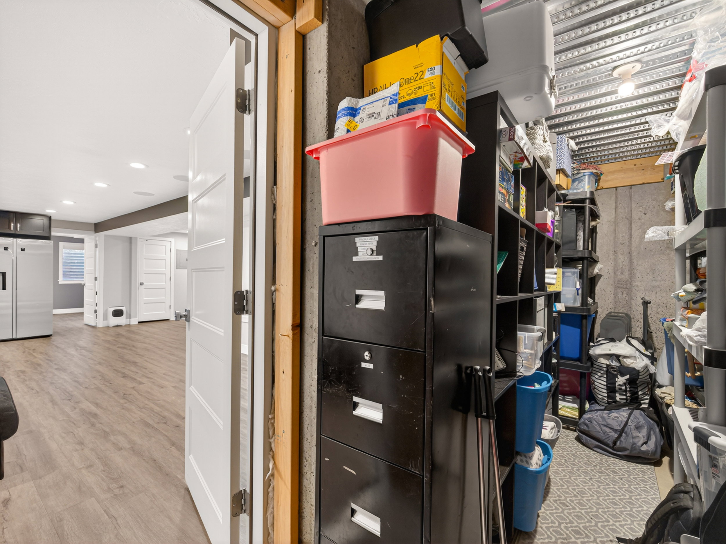 Finished basement space featuring recessed lighting, wood-finish flooring, and white interior doors