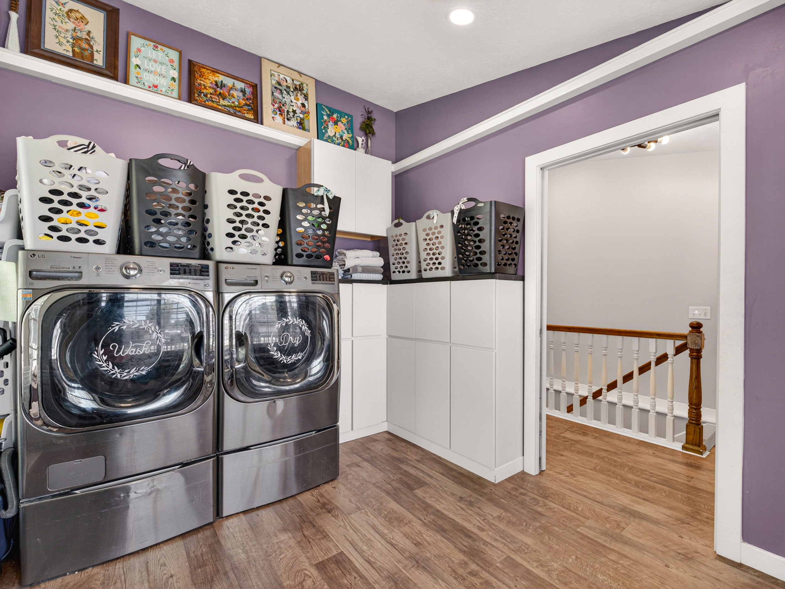 Dedicated laundry area with warm wood-finish flooring