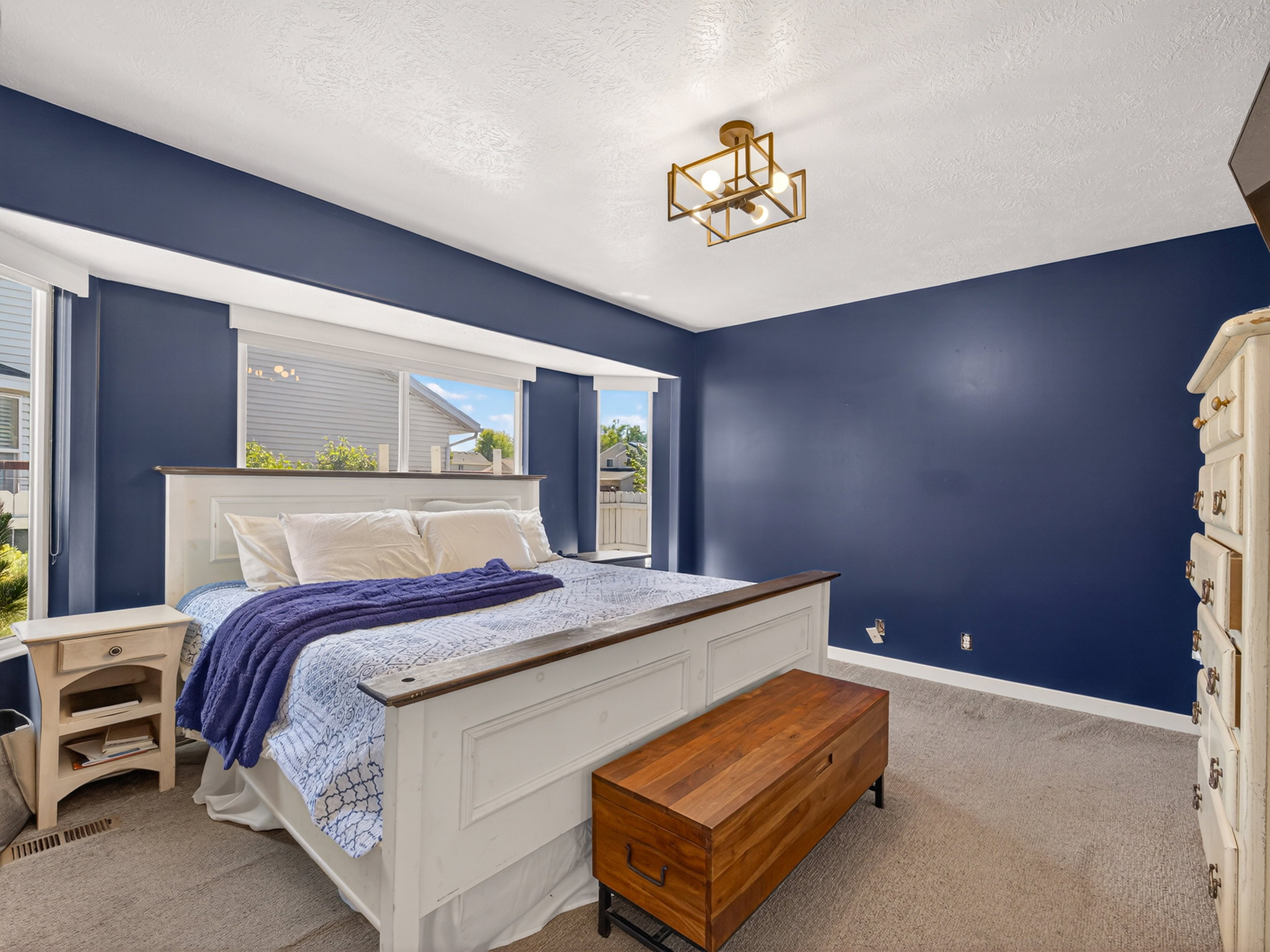 Primary bedroom featuring a bay window, recessed lighting, and a modern geometric ceiling fixture