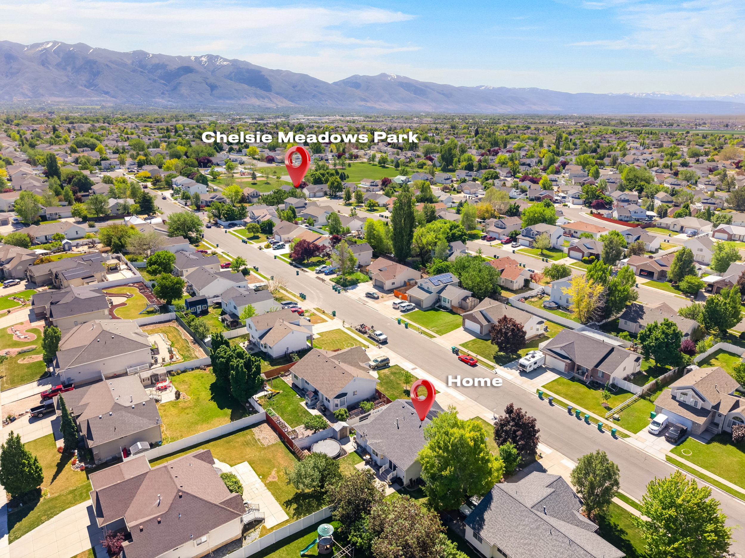 Aerial view showcasing a residential neighborhood with established homes, tree-lined streets, and open green spaces