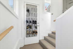 White interior walls with a light wood-finish handrail