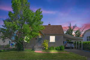 Single-story residence featuring a covered front porch and a carport
