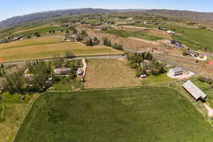 Expansive land parcel featuring multiple structures including a single-story residence, a large barn, and an outbuilding