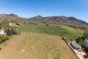 Expansive land parcel featuring open fields and distant mountain ranges