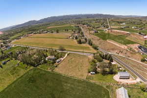 Expansive rural landscape featuring agricultural fields and scattered residential properties
