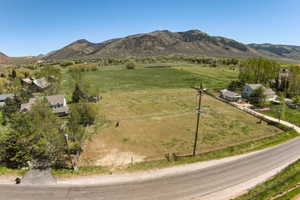 Expansive land parcel featuring open fields and distant mountain scenery