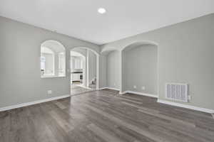 Interior space featuring wood-finish flooring, light grey painted walls, and white baseboards