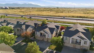 Aerial perspective showcasing a row of multi-story residences with attached garages, individual balconies, and dark-pitched roofs