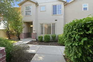 Stucco exterior featuring multiple windows with grid patterns