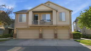 Contemporary multi-unit residence featuring neutral-toned stucco siding and individual garage doors