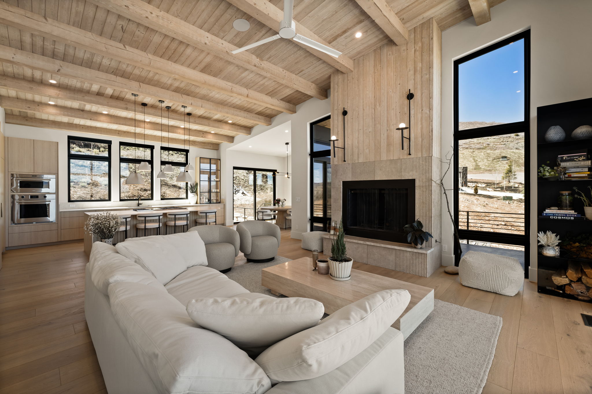 Vaulted wood-beam ceiling featuring a contemporary fan