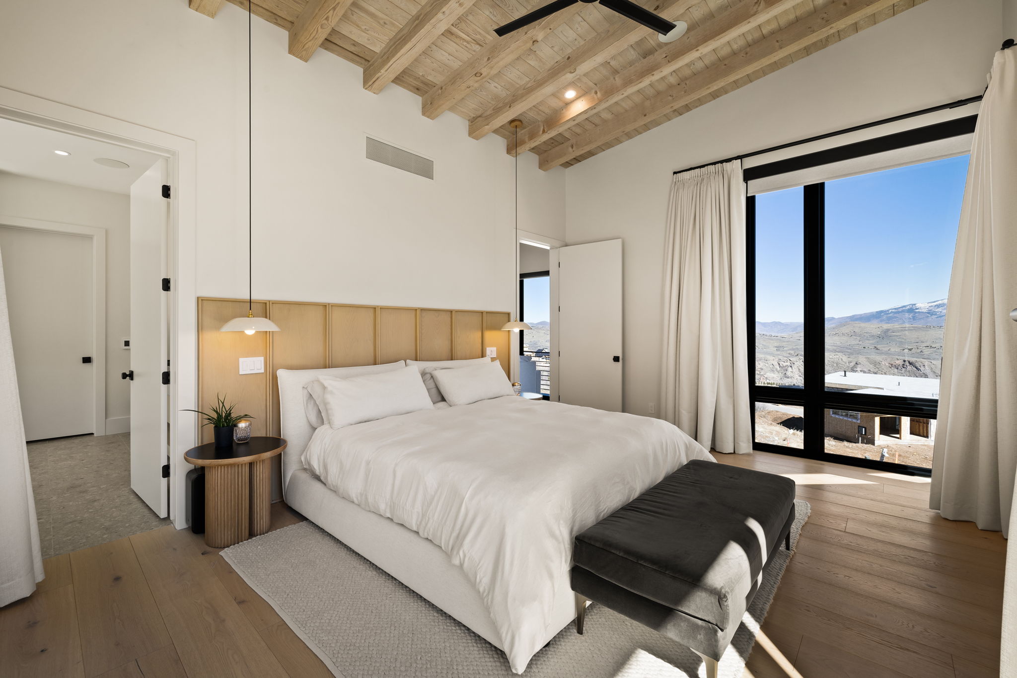 Vaulted wood-beamed ceiling featuring a ceiling fan