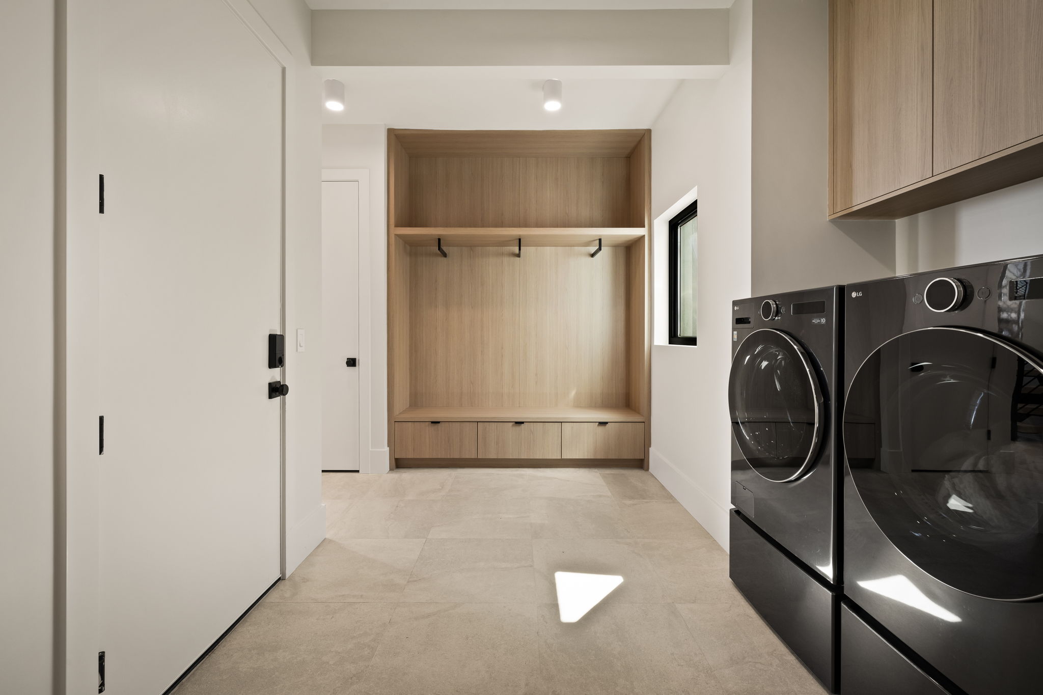 Dedicated laundry area featuring modern black washer and dryer units