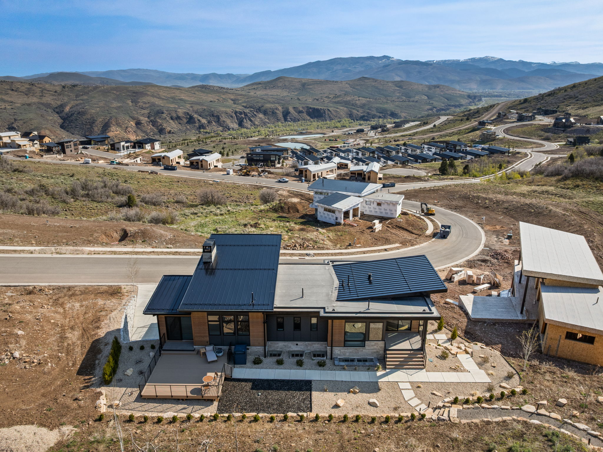 Modern-style residence featuring a multi-level roofline with dark metal and flat sections
