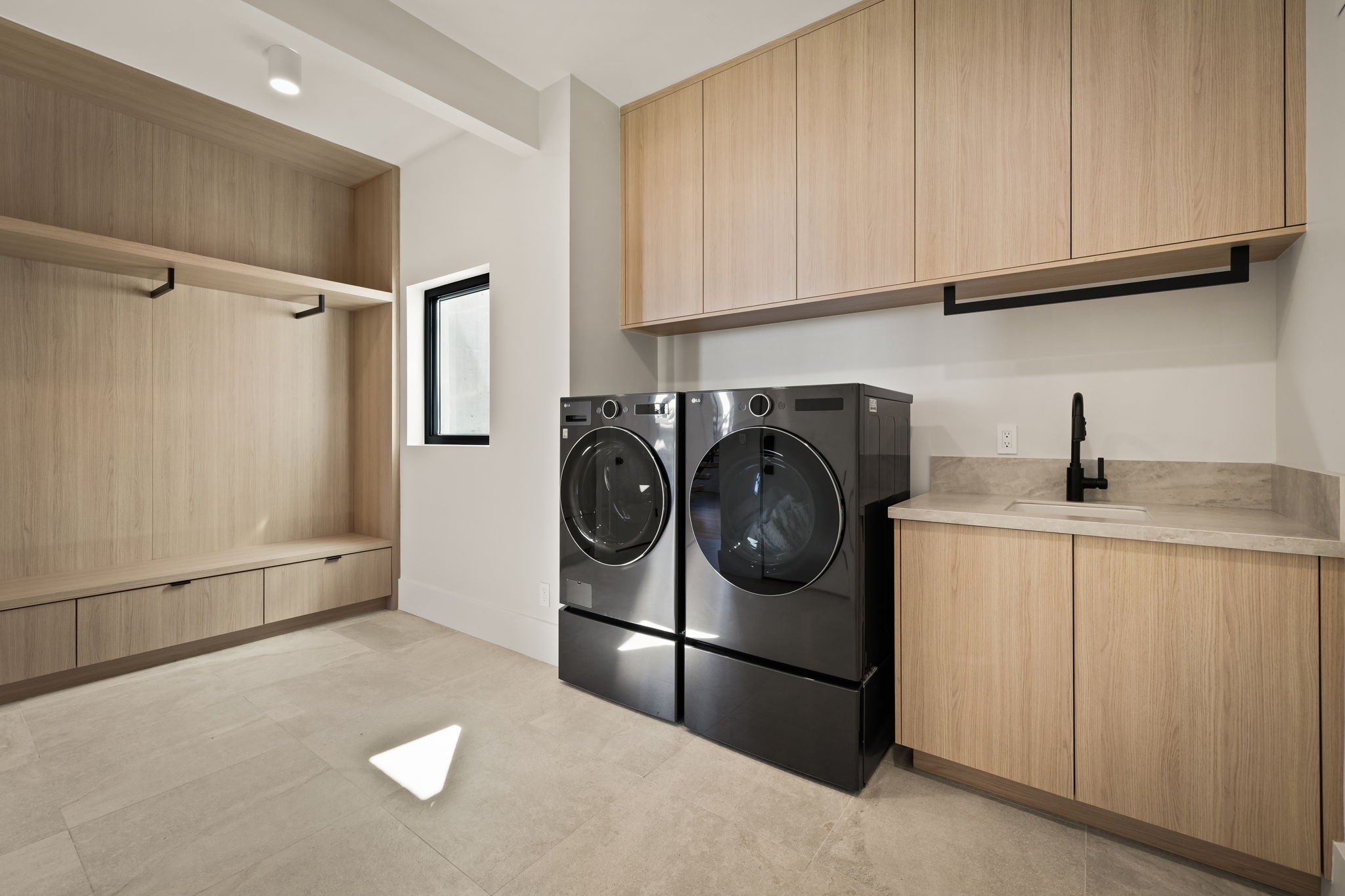 Light wood-finish cabinetry and built-in storage with integrated drawers