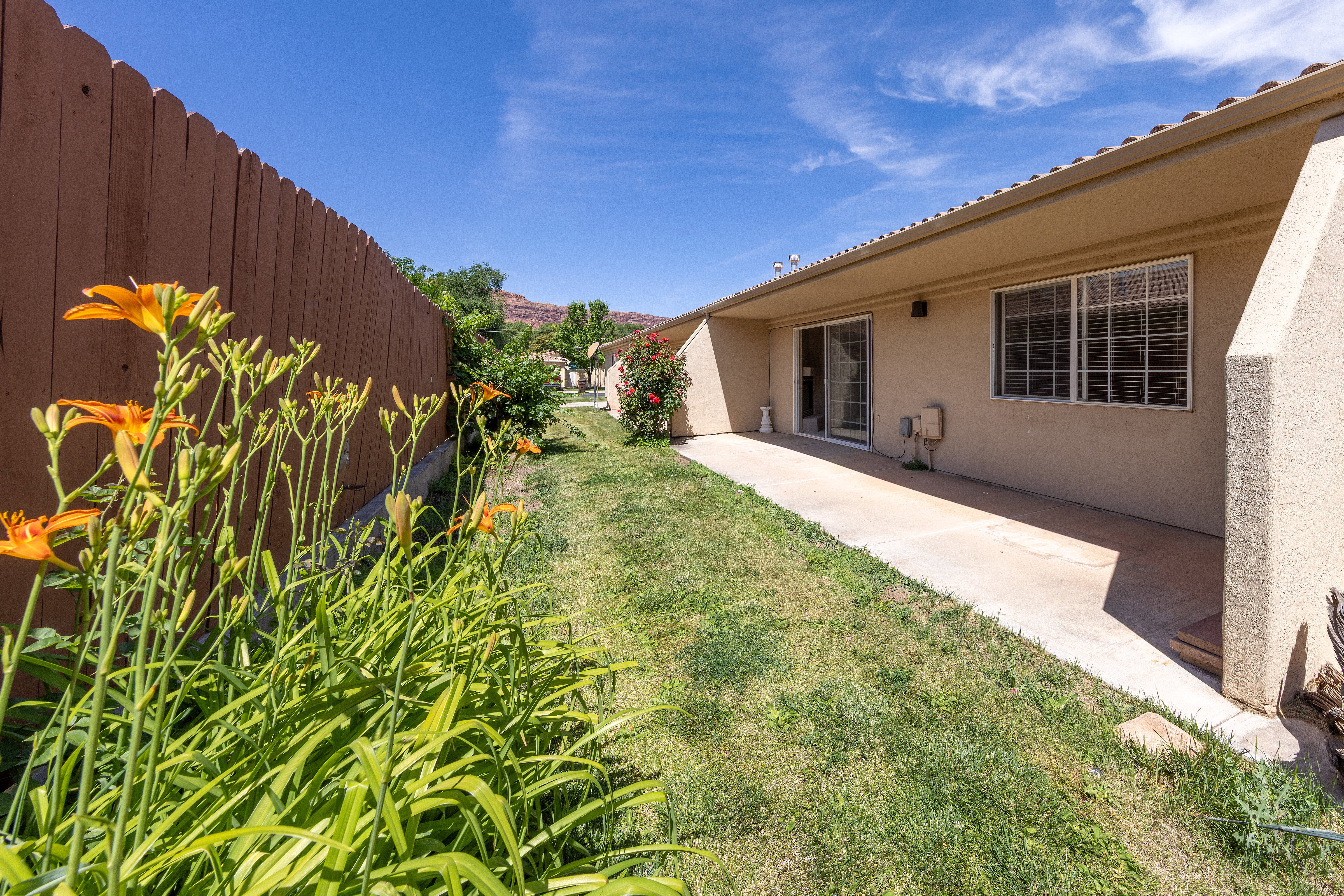 Expansive concrete patio with direct access via a glass sliding door