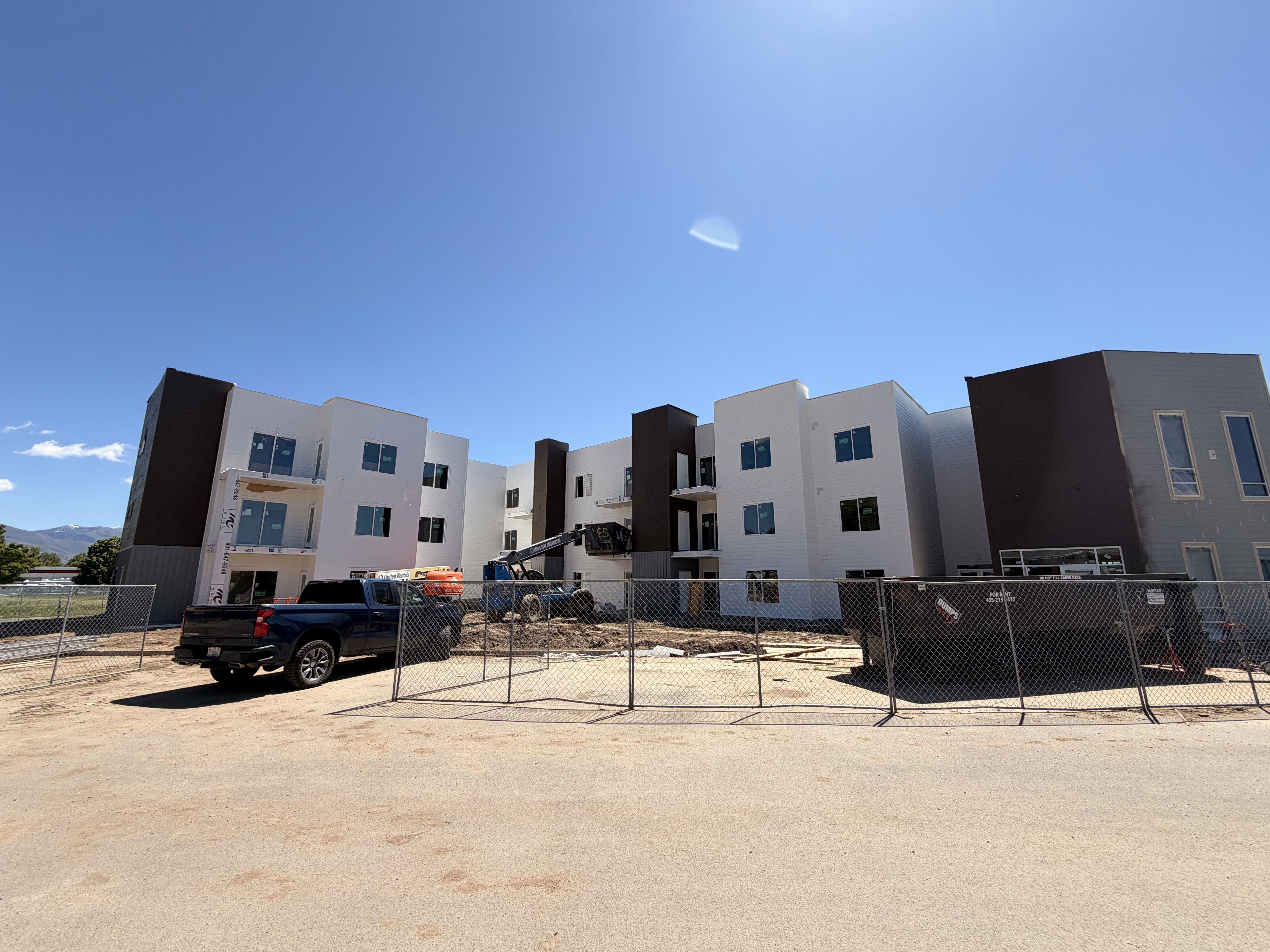 Multi-story building featuring white and dark gray exterior finishes with modern architectural lines