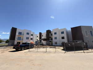 Multi-story building featuring white and dark gray exterior finishes with modern architectural lines