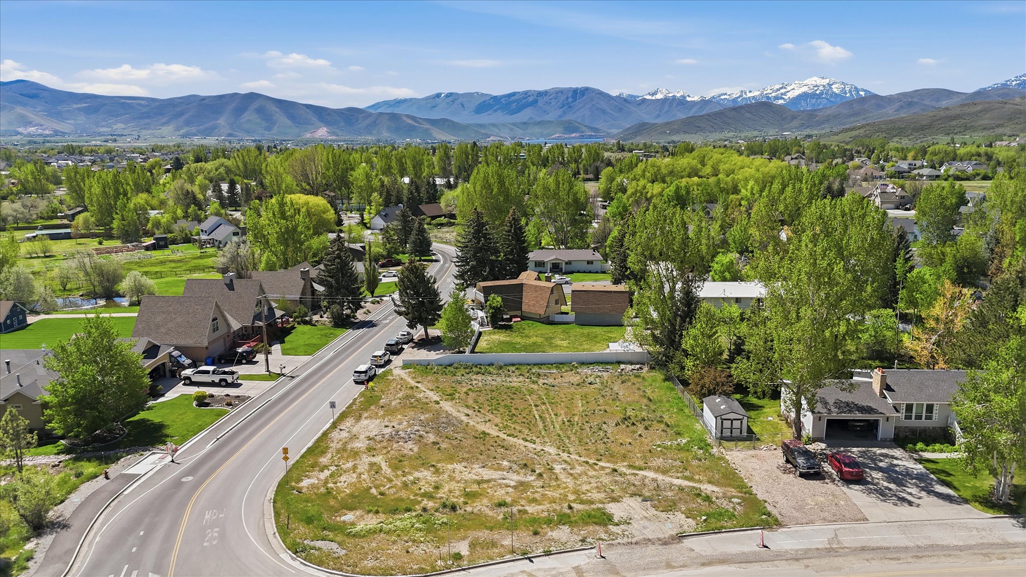 Expansive lot featuring a wide street frontage and a mountain backdrop