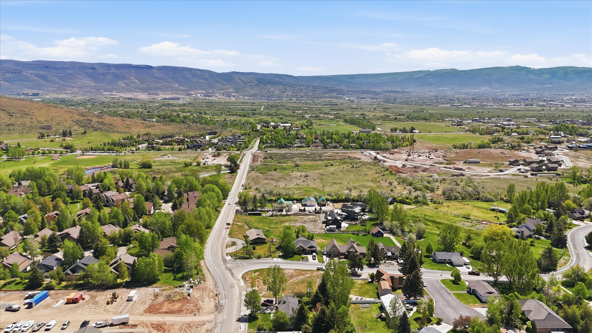 Expansive mountain valley landscape featuring residential developments and undeveloped land