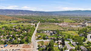 Expansive mountain valley landscape featuring residential developments and undeveloped land