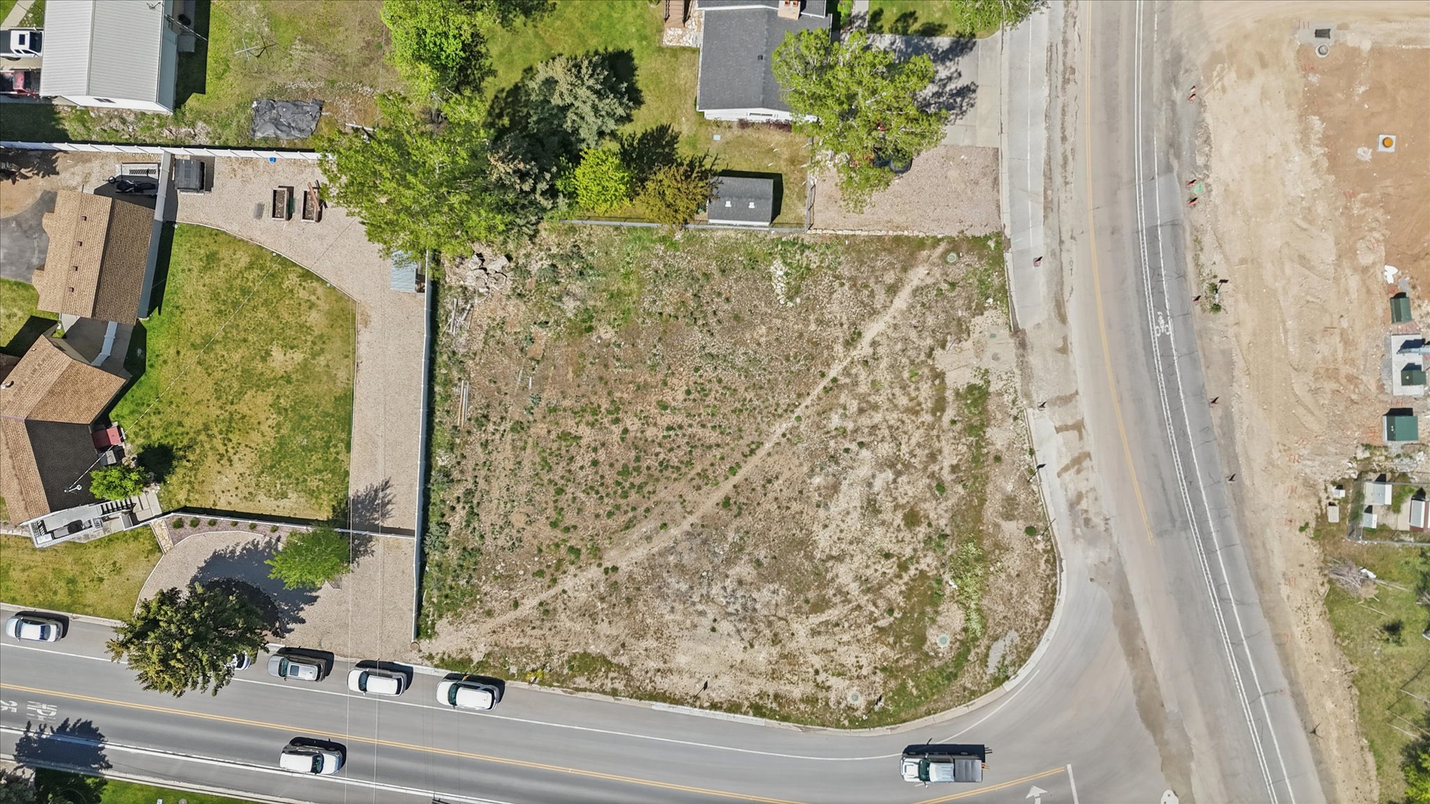 Vacant land parcel featuring direct road frontage and established surrounding properties