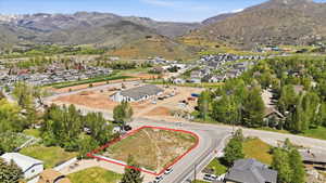 Corner lot property featuring a defined boundary, direct road frontage, and a surrounding residential area