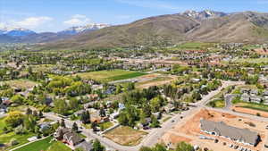 Expansive mountain scenery framing a community with residential properties and open green spaces