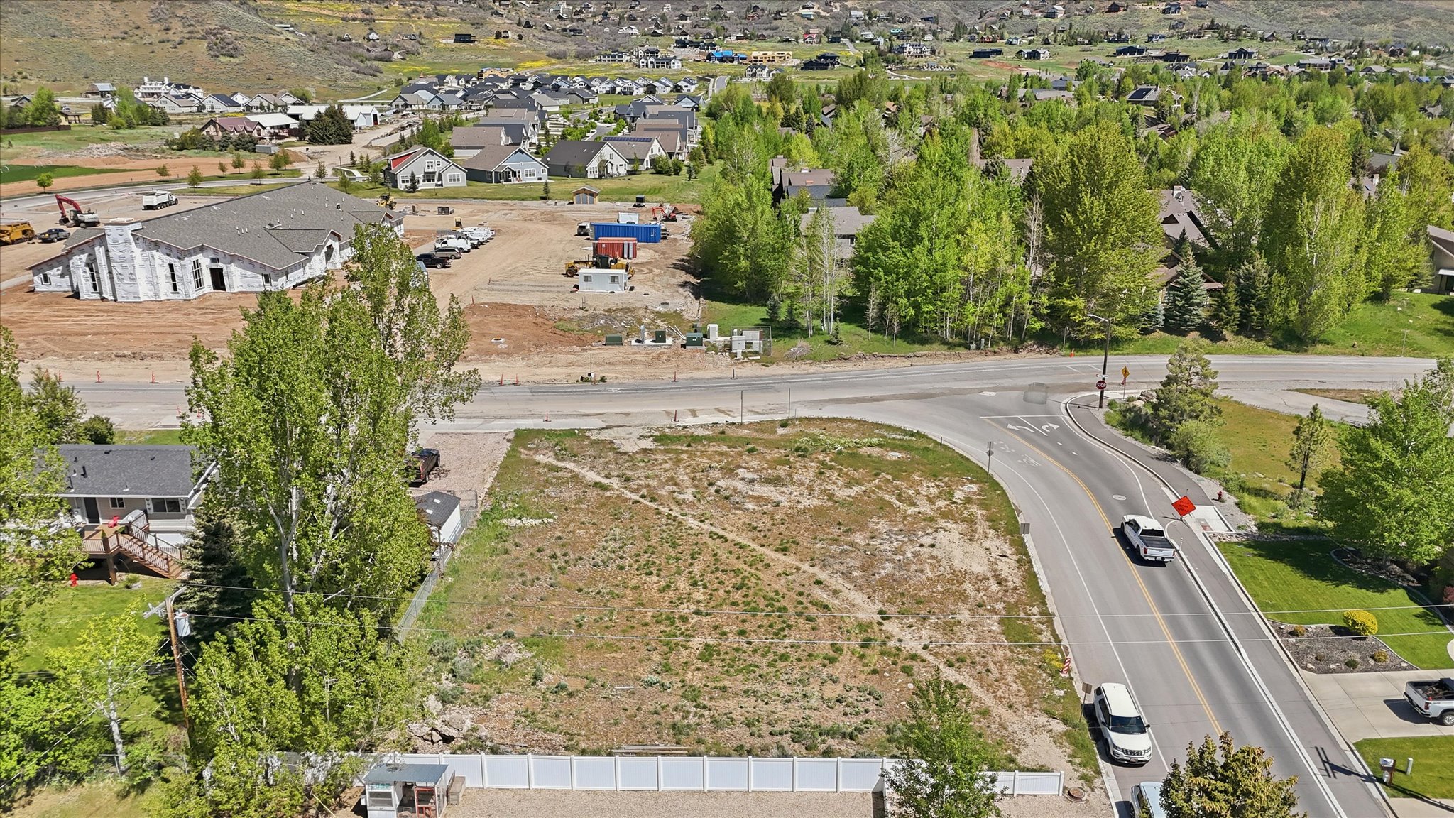 Expansive undeveloped parcel featuring road frontage, a level building area, and surrounding mature trees