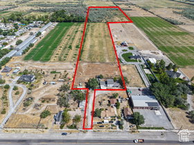Expansive property outlined in red, featuring significant acreage with agricultural fields and undeveloped land