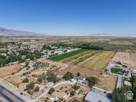 Expansive aerial perspective showcasing a residential area bordered by cultivated fields