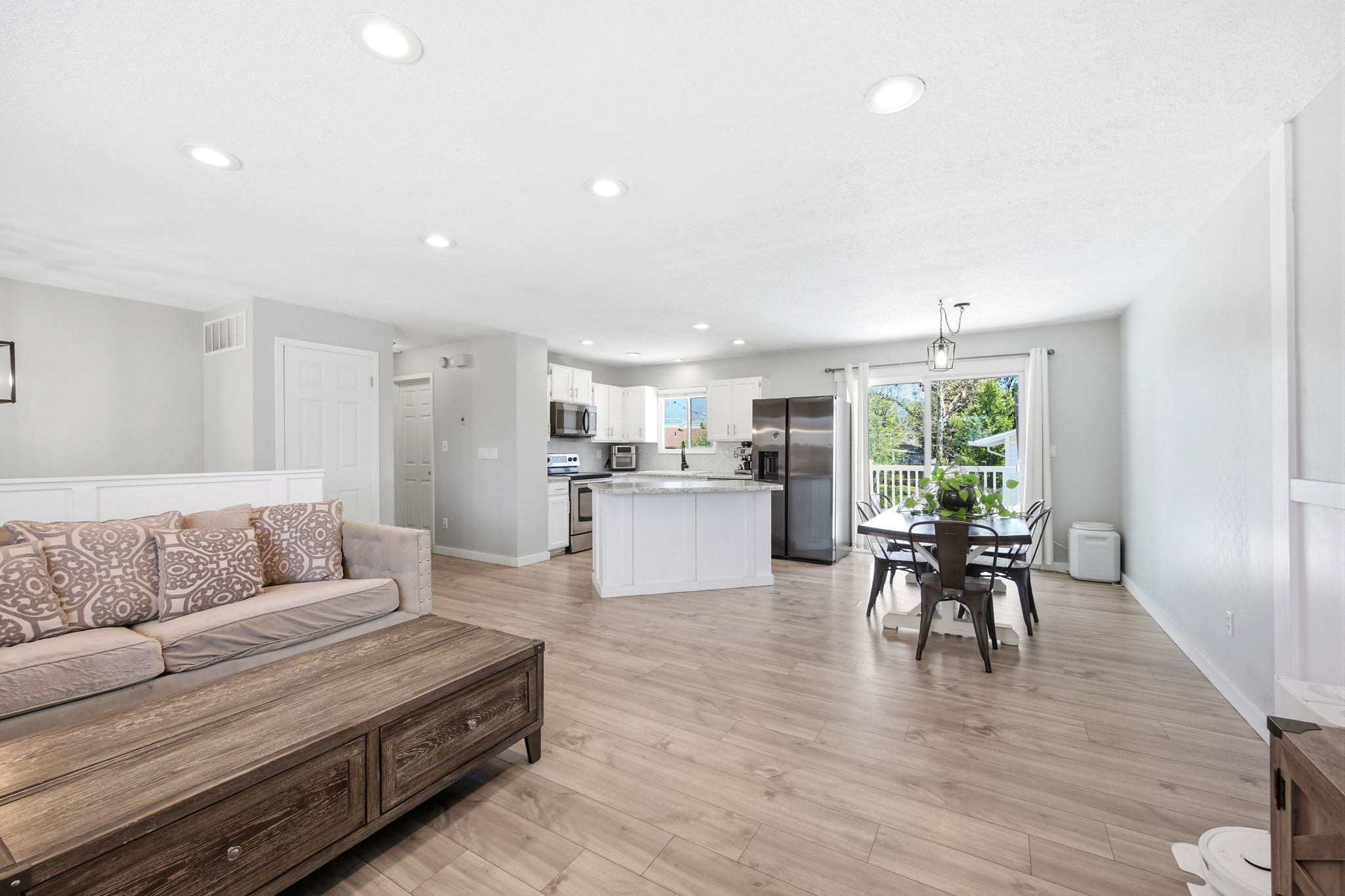 Open-concept living space featuring wood-finish flooring throughout