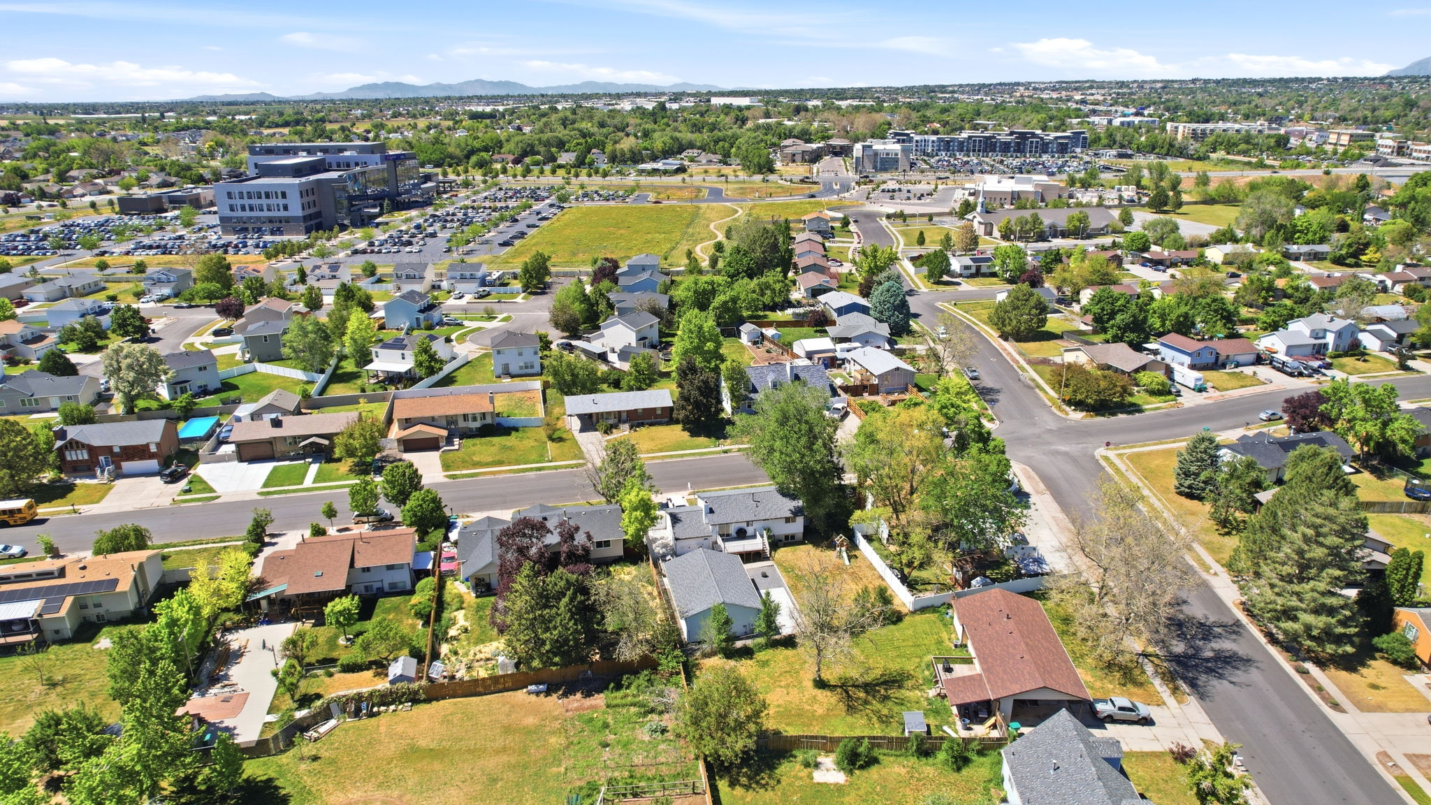 Aerial perspective of a residential neighborhood with a mix of single-family homes and mature trees