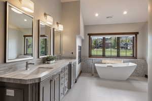 Dual vanity with undermount sinks, stone countertops, and framed mirrors
