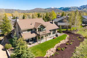 Contemporary mountain-style residence featuring a multi-level design, a prominent balcony, and a brown shingle roof