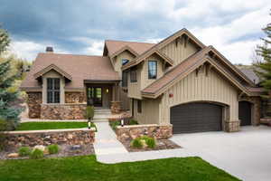 Craftsman-style exterior featuring stone and board-and-batten siding