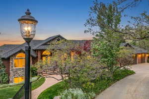 Stone and brick facade residence featuring an arched entry, multiple gables, and an attached two-car garage