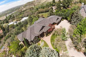 Expansive property featuring a multi-level residence with a shingle roof and multiple gables