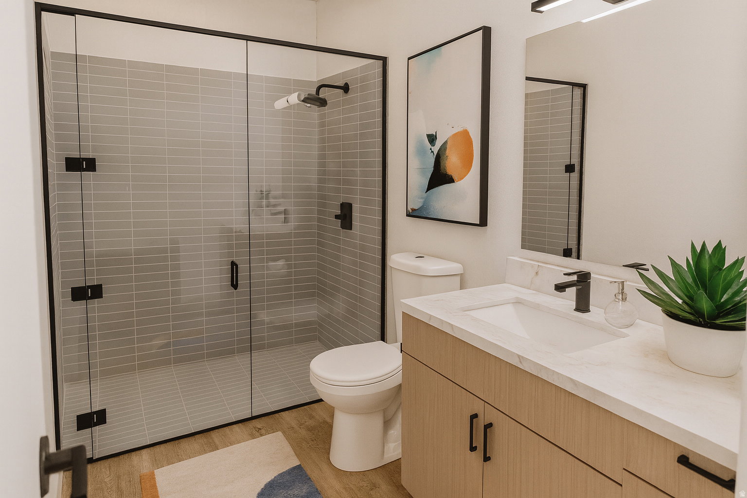 Contemporary bathroom featuring a spacious glass-enclosed shower with subway tile surround, a single vanity with a light wood-finish cabinet and stone-look countertop, a rectangular undermount sink, and matte black fixtures throughout