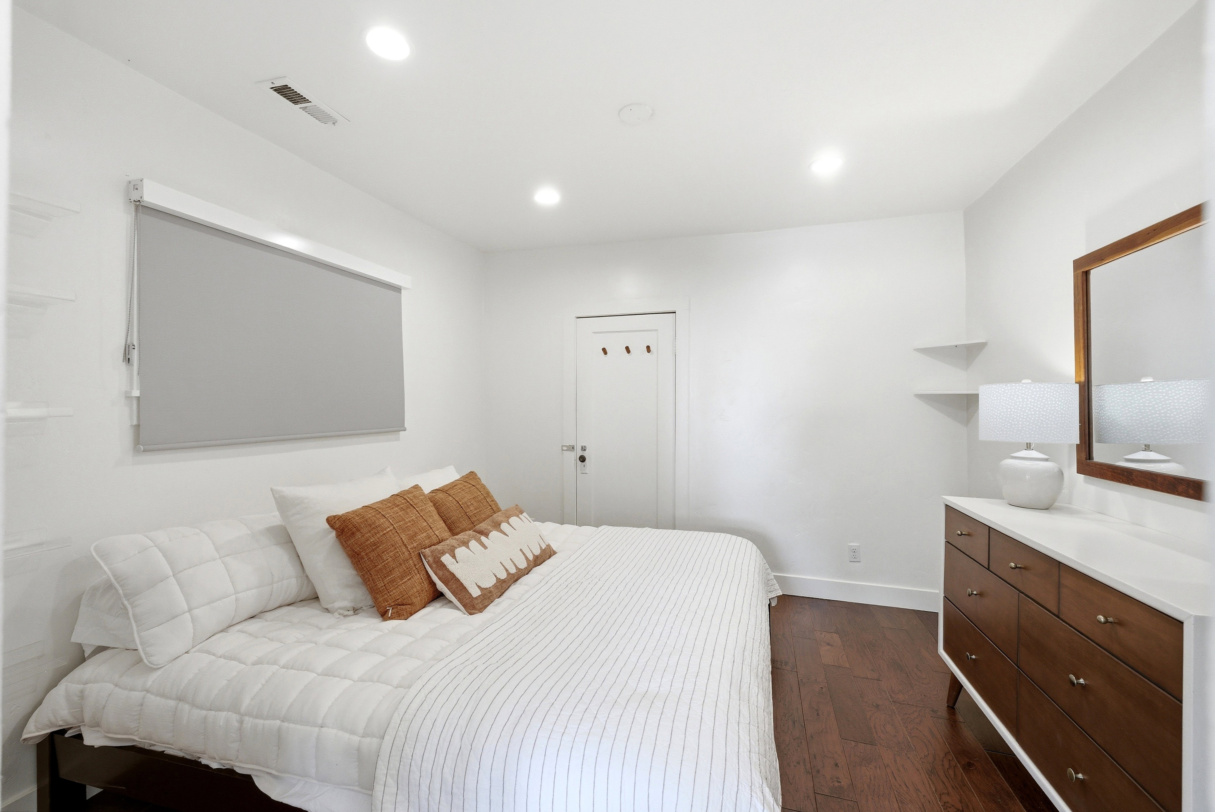 Hardwood-style flooring throughout this room with recessed ceiling lighting