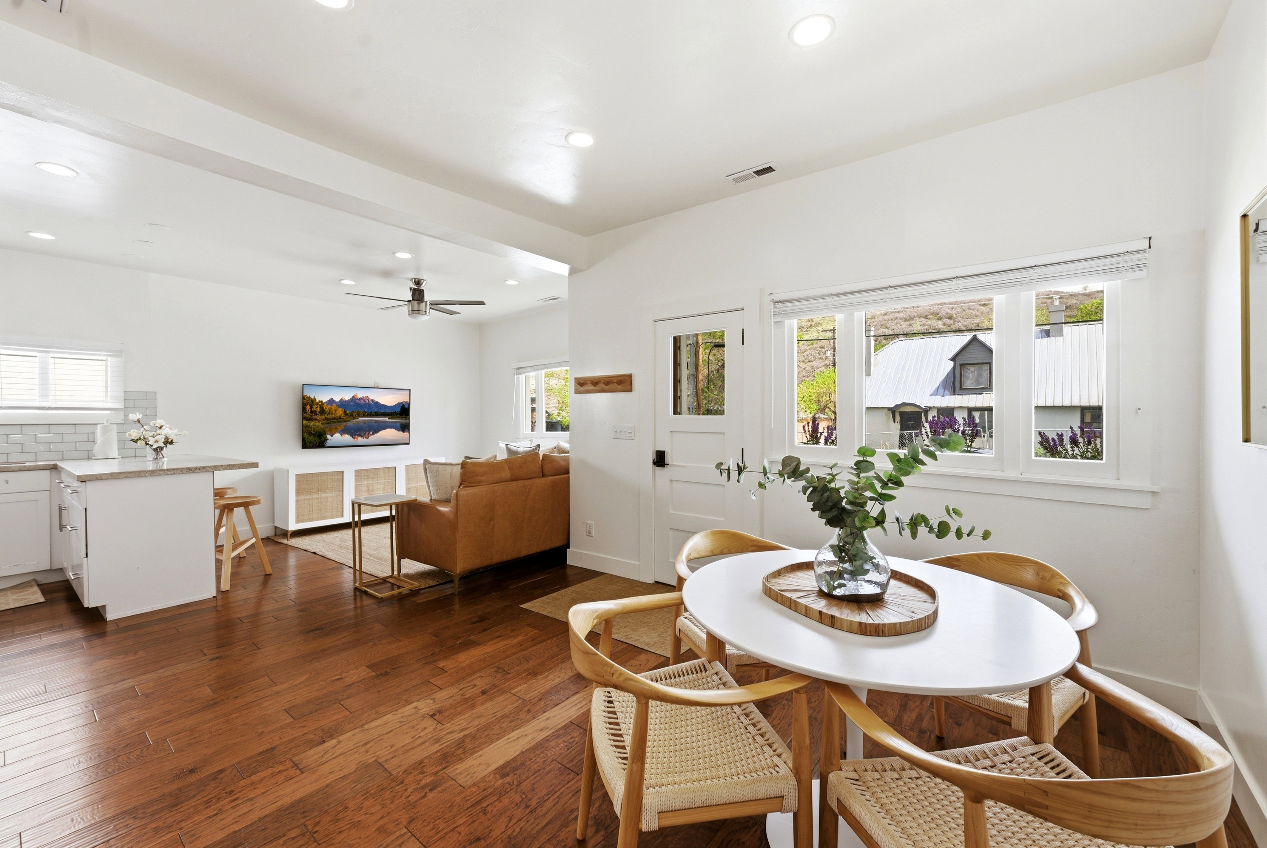 Open-concept living space featuring wood-finish flooring, recessed lighting, and a neutral color palette