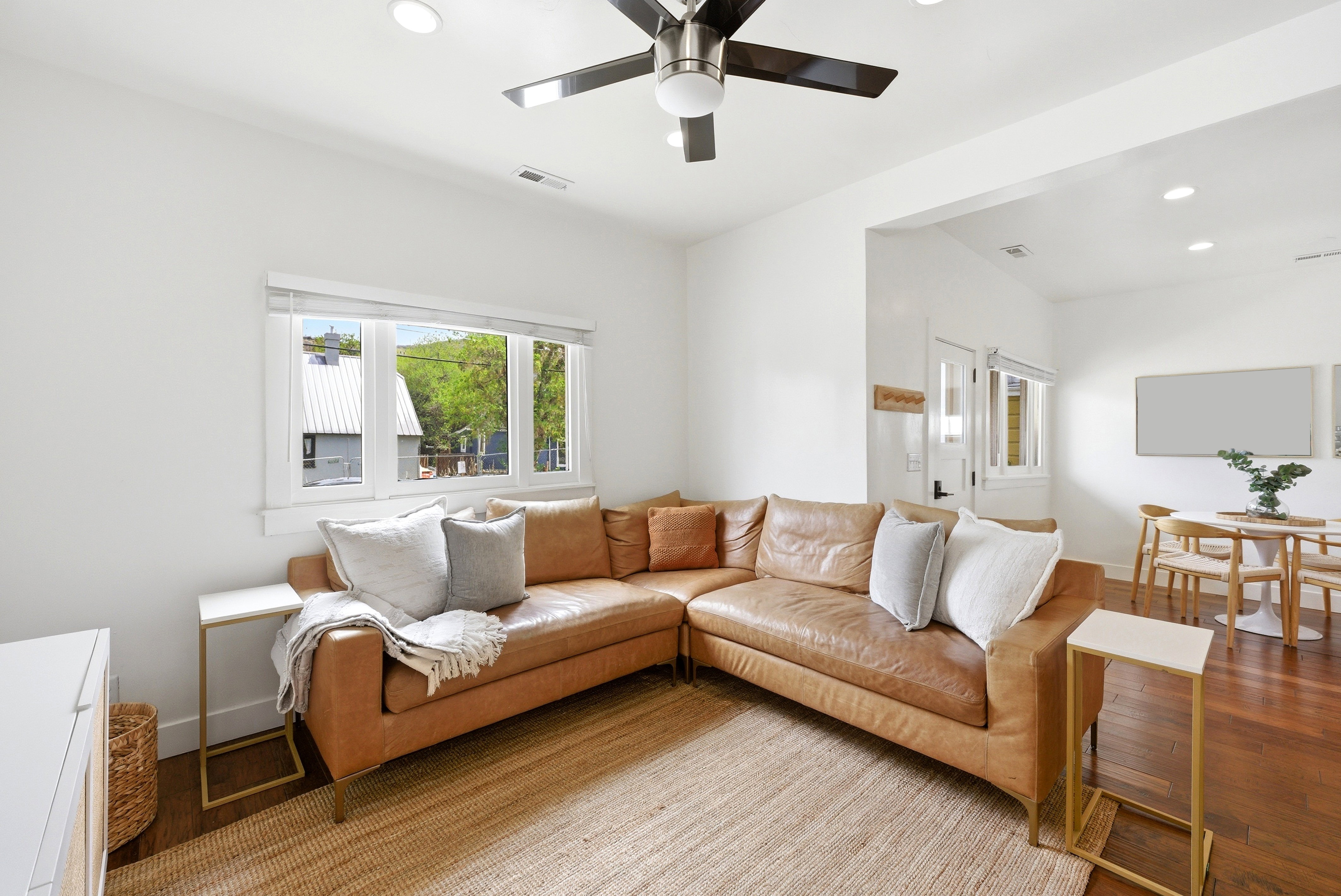 Spacious living area featuring high ceilings, recessed lighting, and wood-finish flooring