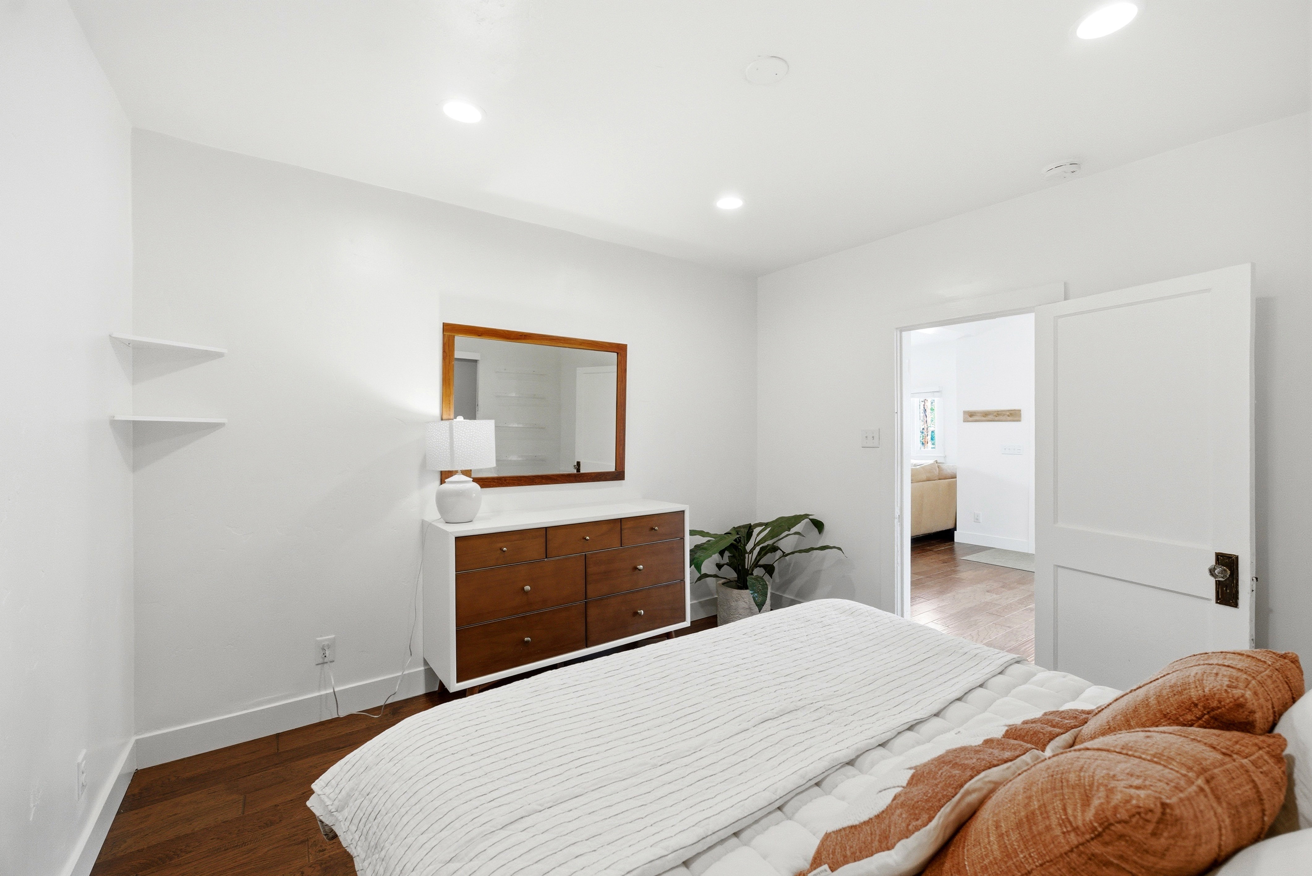 Bright interior space featuring recessed lighting, wood-finish flooring, and white baseboards