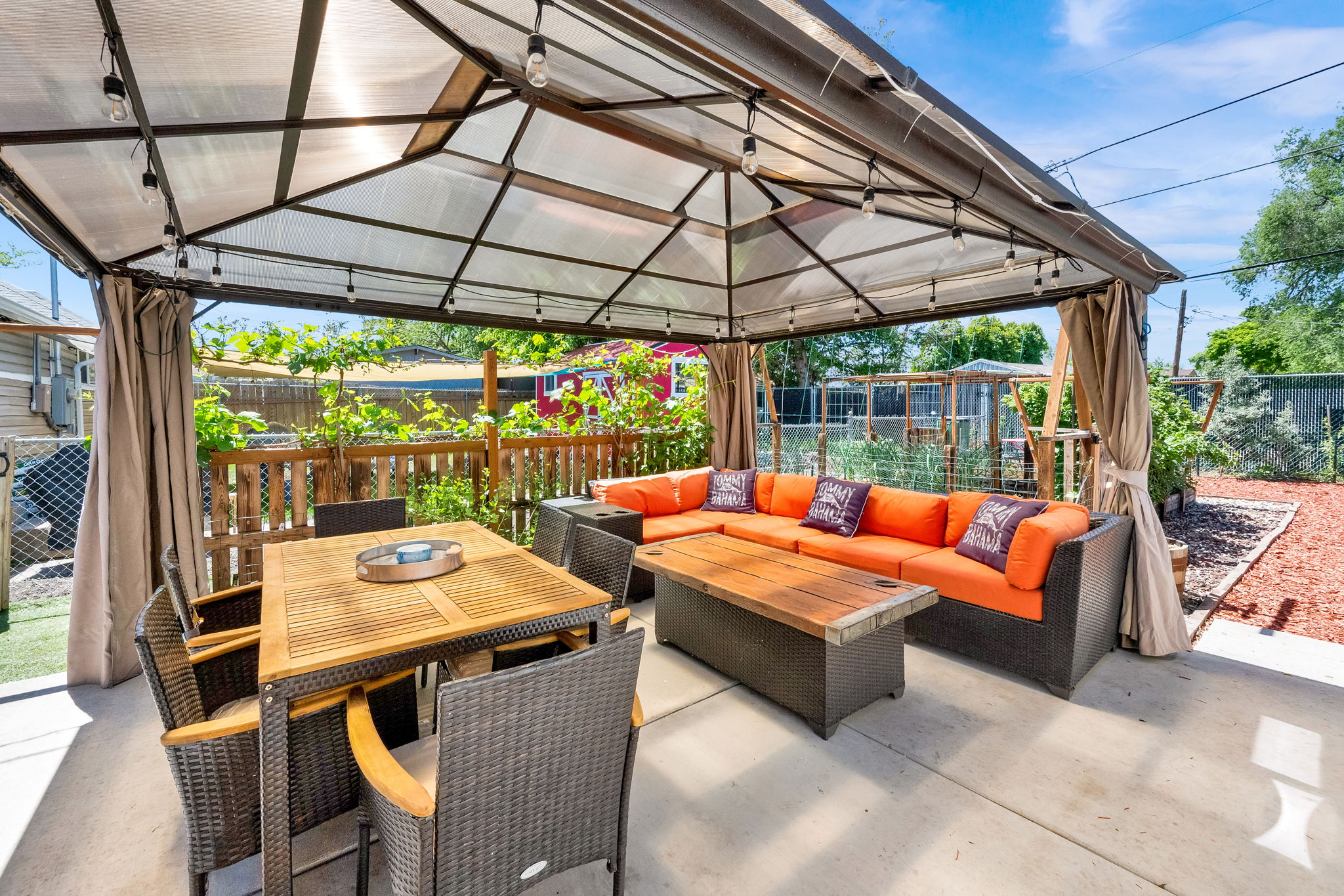 Outdoor patio featuring a covered gazebo with string lighting
