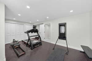 Recreational room featuring recessed lighting, a neutral color palette, and durable dark-toned flooring