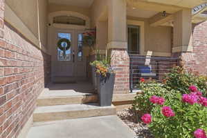 Brick and stucco exterior featuring a covered entryway