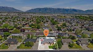 Aerial perspective showcasing the residential neighborhood with a prominent mountain range backdrop